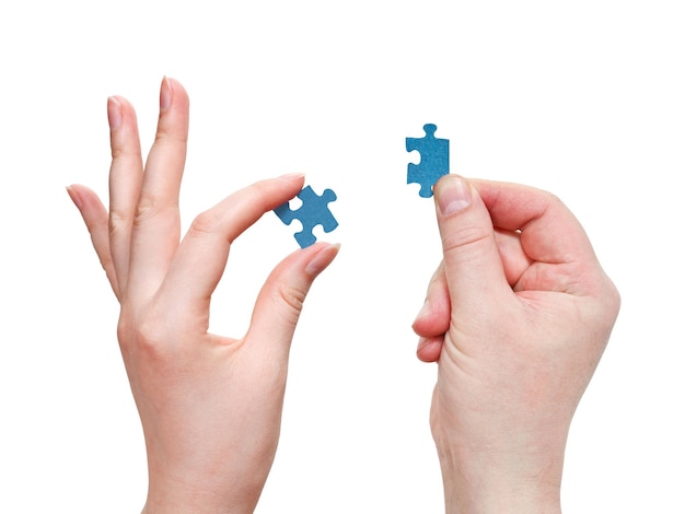 Male and female hands with little puzzle pieces