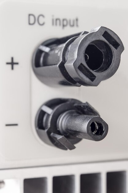Photo male and female mc4 connectors on the bottom side of power inverter for connecting to solar panel