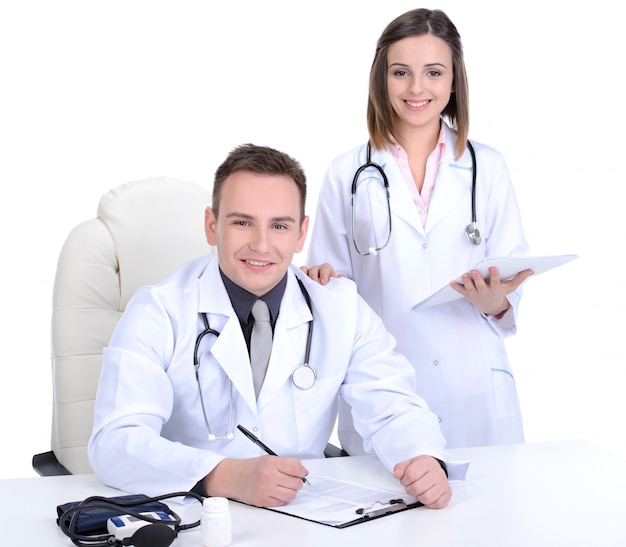 Male and female medical doctors pose together.