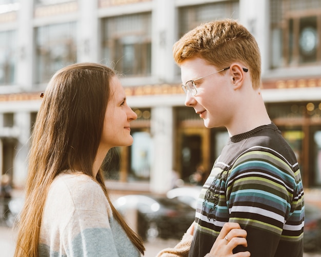 Male and female person looking at each other, young couple full of love. The redhead boy 