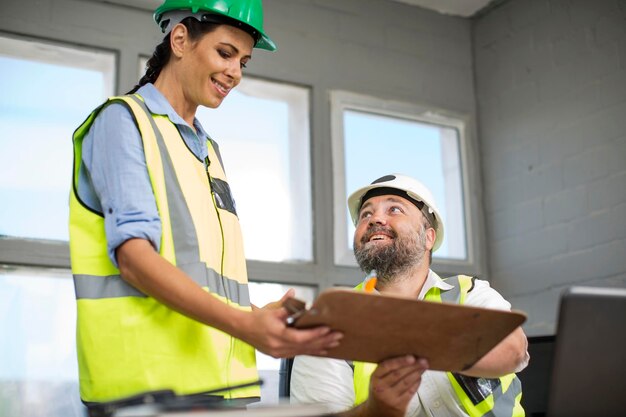 Male and female quarry staff having a meeting in site office