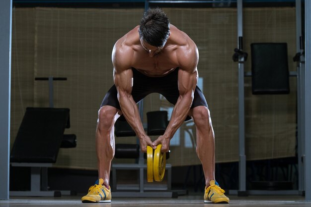 Male Fitness Athlete Doing Heavy Weight Exercise For Back