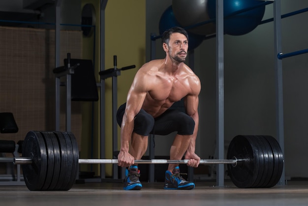 Male Fitness Athlete Lifting Deadlift In The Gym