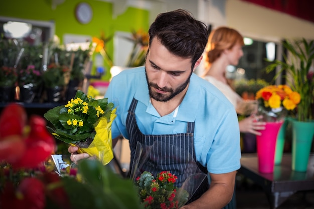 Male florist arranging flower bouquet