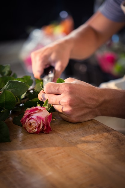 Male florist preparing flower bouquet