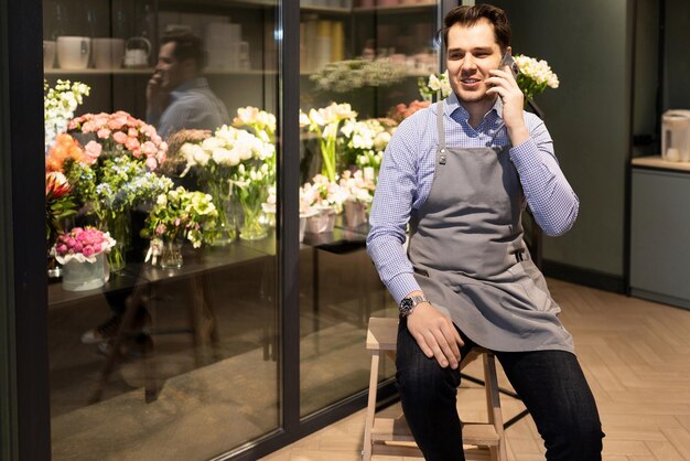Male florist takes an order by phone for delivery