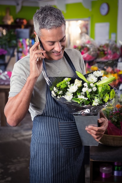 Male florist talking on mobile phone