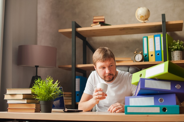 Male freelancer at home working on a laptop.