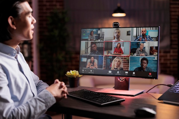 male freelancer talking on online videocall meeting with webcam on computer, working from home. using telework videoconference to have remote conversation, internet telecommunications.
