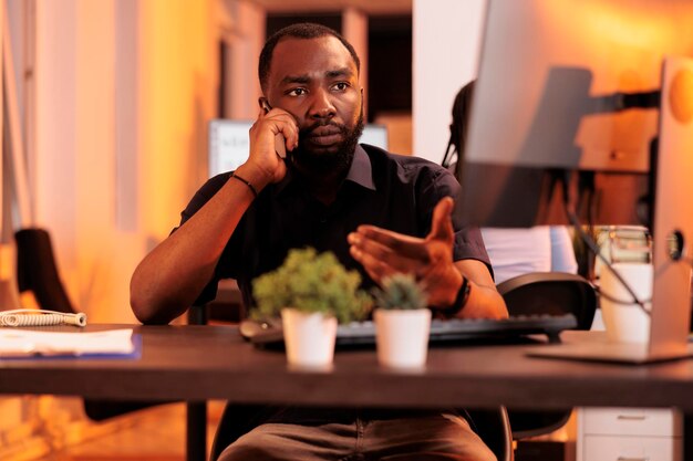 Male freelancer using mobile phone to call manager at job person