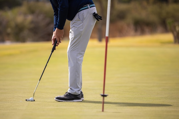 Male golf player hitting the ball