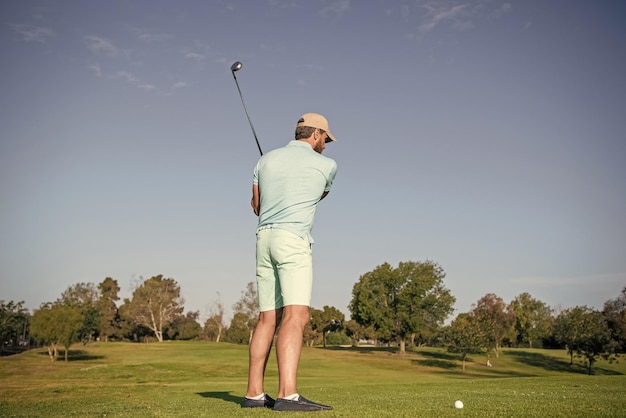 Male golf player on professional golf course portrait of golfer in cap with golf club