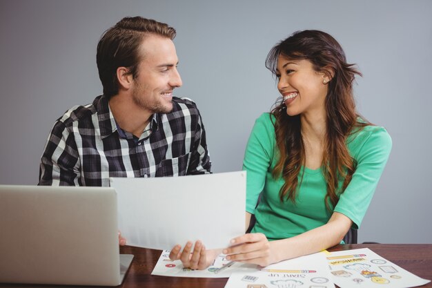 Male and graphic designers working together in conference room