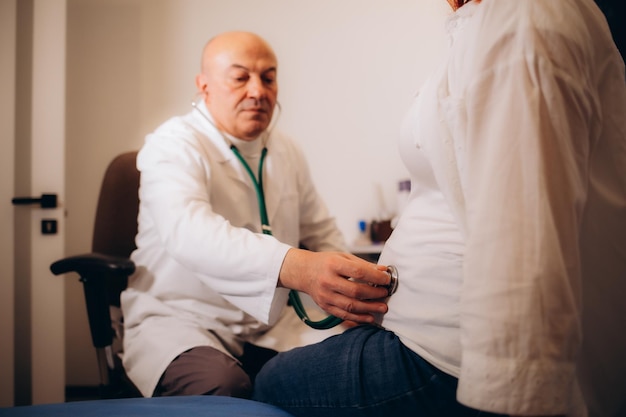 Male gynecologist working with woman in clinic