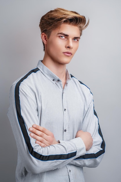 Male hairstyle concept handsome guy with stylish haircut in
stands over white background