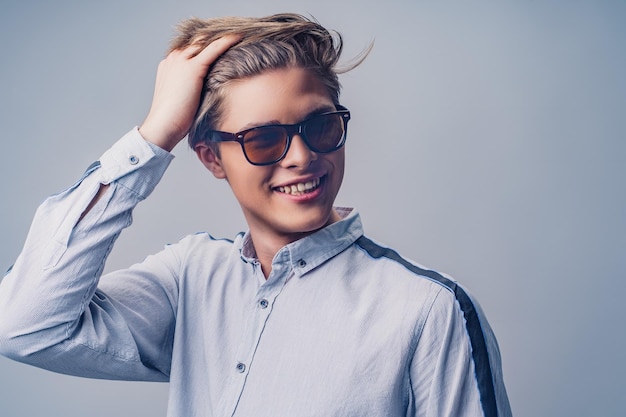 Male hairstyle concept portrait of hipster smiling man with stylish haircut in sunglasses