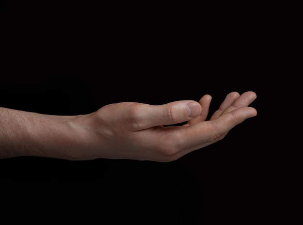 Male hand on black background