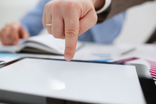 A male hand in a business suit makes a clean display