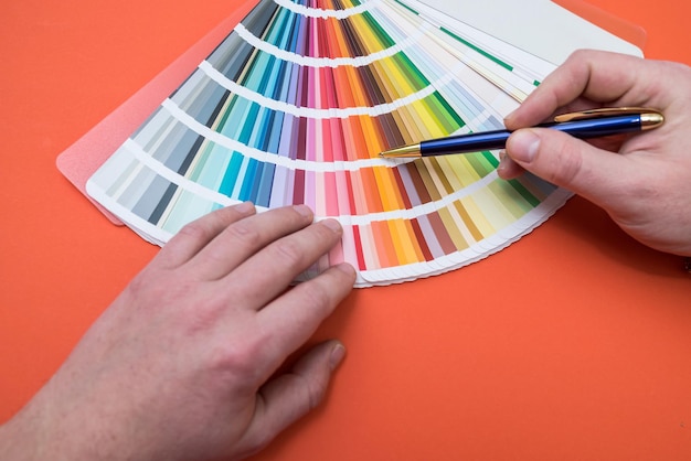 Male hand choose color in palette samples