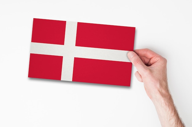 Male hand holding denmark flag