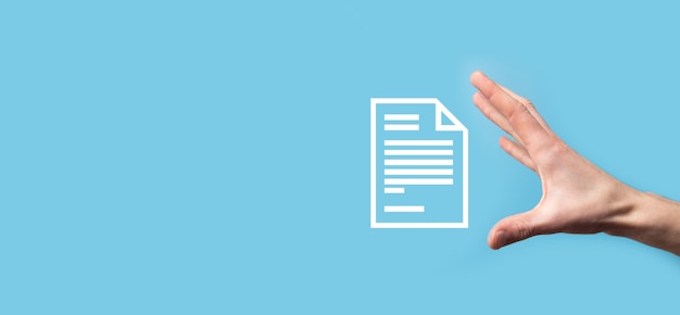 Male hand holding a document icon on blue surface