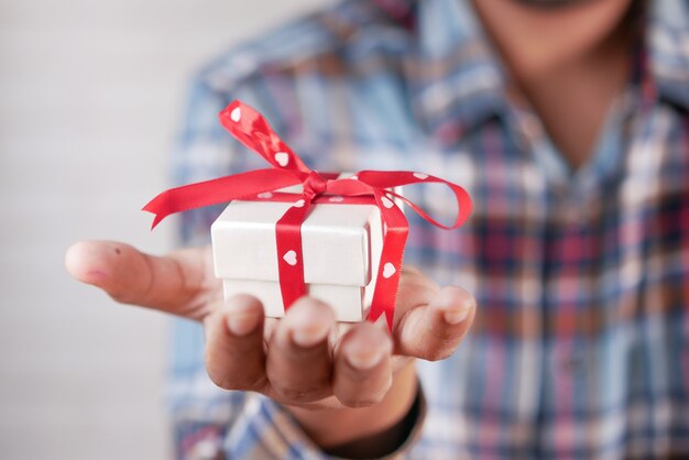 male hand holding gift box closeup