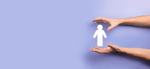 Male hand holding human icon on blue background. Human Resources HR management Recruitment Employment Headhunting Concept.Select team leader concept. Male hand click on man icon.Banner ,copy spase.