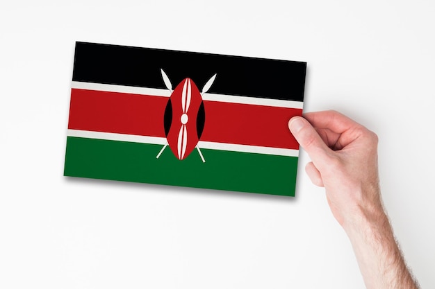 Male hand holding kenya flag