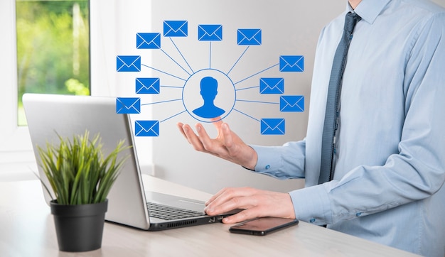 Photo male hand holding letter icon,email icons .contact us by newsletter email and protect your personal information from spam mail. customer service call center contact us.email marketing and newsletter