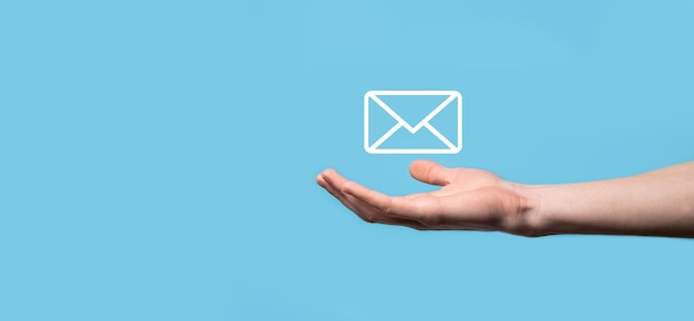 Male hand holding letter icon,email icons .Contact us by newsletter email and protect your personal information from spam mail. Customer service call center contact us.Email marketing and newsletter.