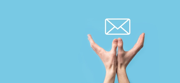 Male hand holding letter icon,email icons .Contact us by newsletter email and protect your personal information from spam mail. Customer service call center contact us.Email marketing and newsletter.