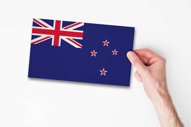 Male hand holding new zealand flag