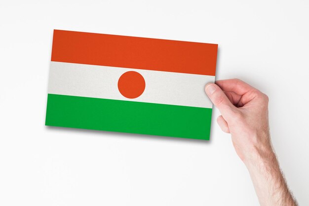 Male hand holding niger flag