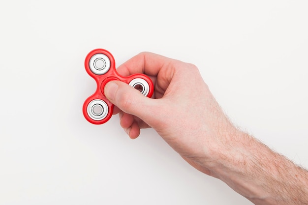 Male hand holding popular fidget spinner toy