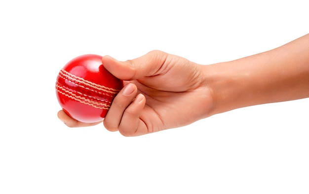 Photo a male hand holding a red test match leather stitch cricket ball closeup picture white background