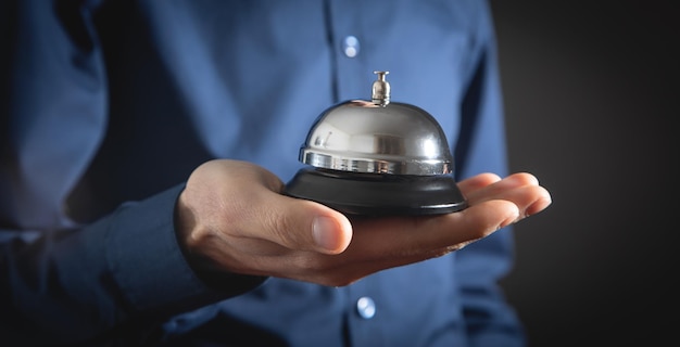 Male hand holding service bell at office