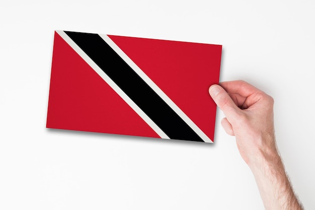 Male hand holding trinidad flag