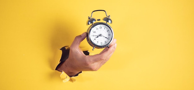 Male hand holding vintage clock