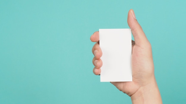 Male hand holding white blank card