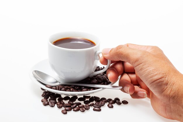 Male hand holding white coffee cup and coffee beans on white 