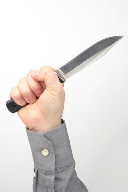 Male hand holds a knife on a white background