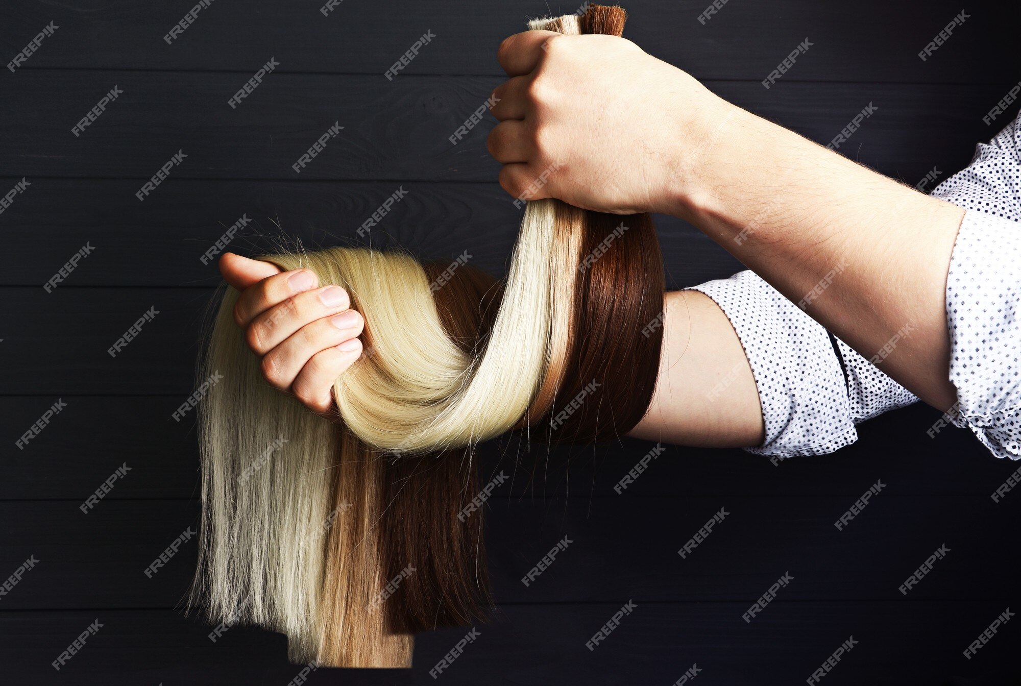 Premium Photo | The male hand holds sections of hair for types of ,red and brown-haired extensions concept. Premium Photo | The male hand holds sections of hair for types of ,red and brown-haired extensions concept.