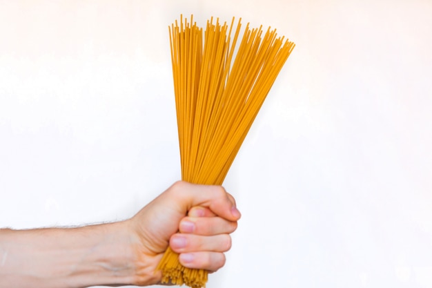 Male hand holds spaghetti