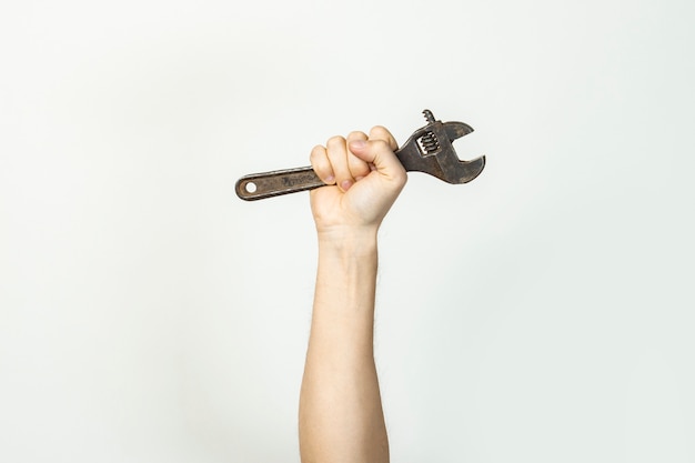 Male hand holds a wrench on a light