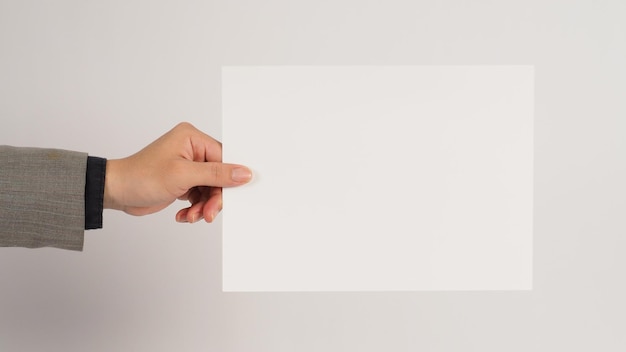 The male hand is holding the A4 paper board on white background