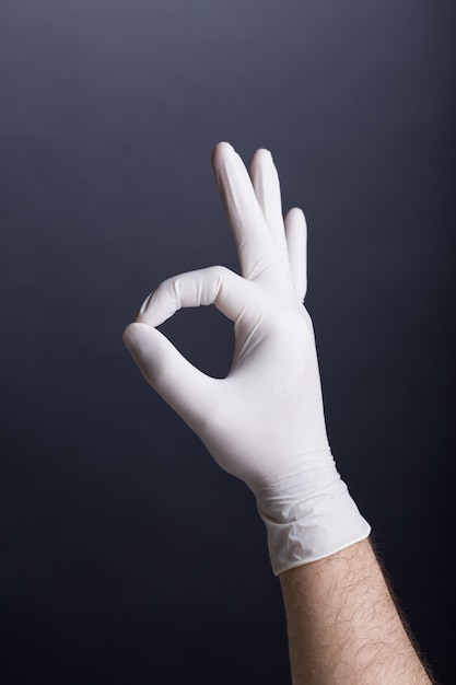 ラテックス手袋の男性の手（OKサイン）