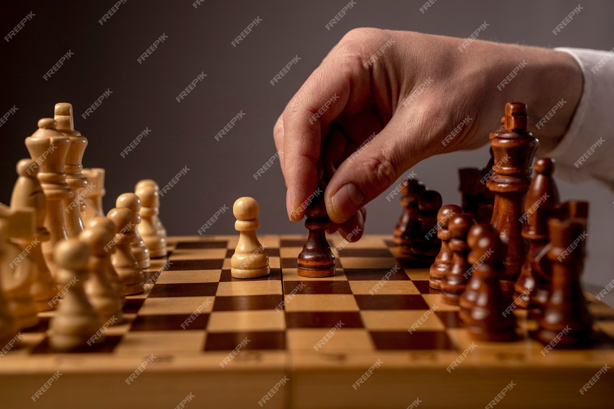 Drawing on white background of someone moving a pawn on a chess board with  impact effects