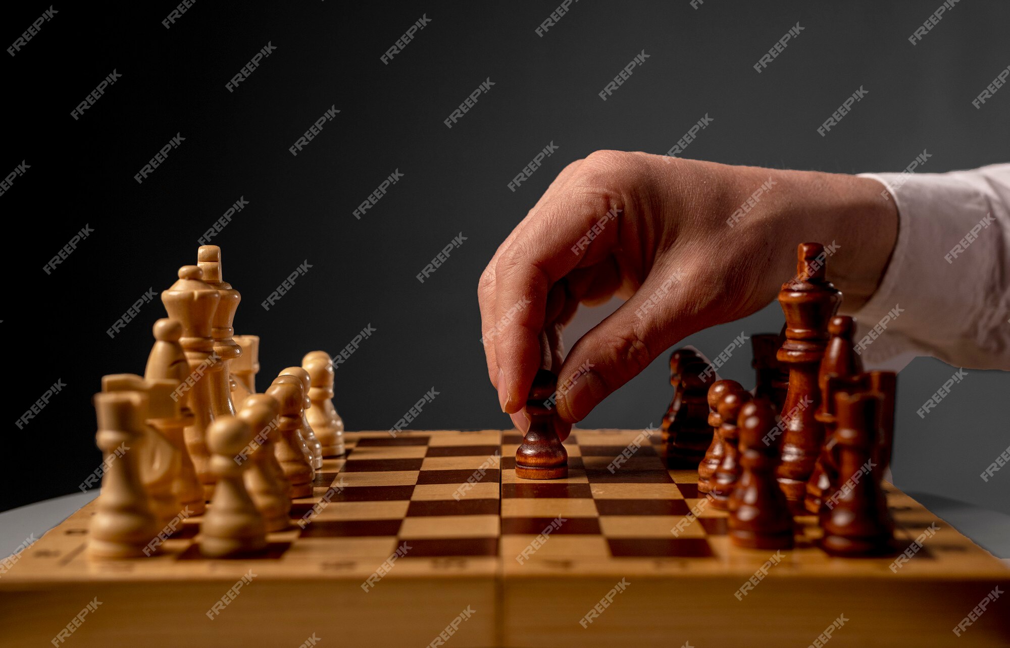 Drawing on white background of someone moving a pawn on a chess board with  impact effects