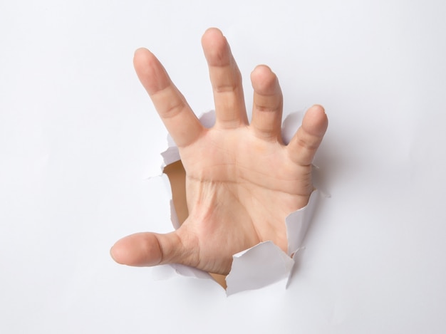 Male hand  punching through the paper