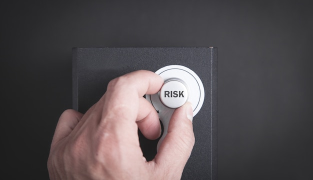 Male hand and Risk button. Risk Management